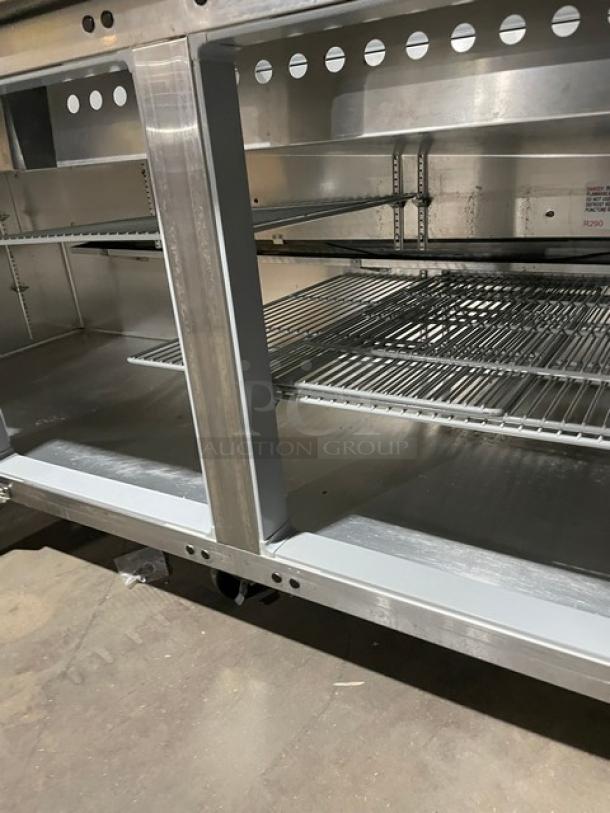 Continental stainless steel refrigerated prep table, model RA93N30M, features poly coated wire rack, on casters.