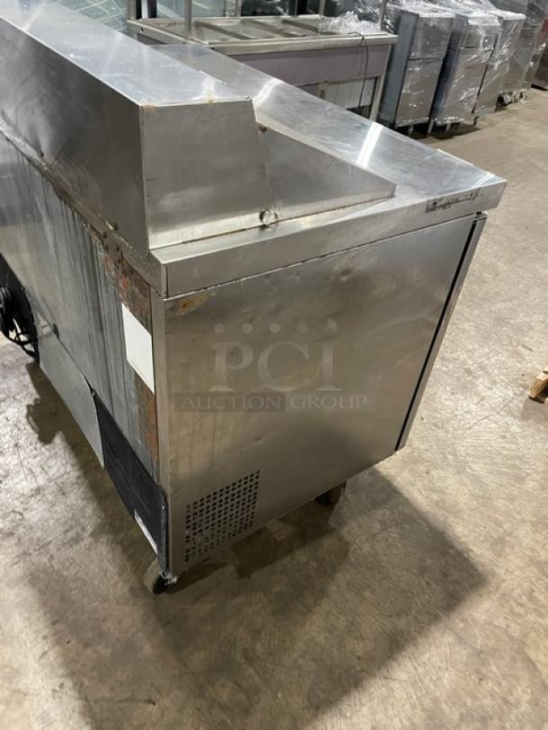 Atosa stainless steel 2-door refrigerated prep table, Model MSF8302, on casters, with visible wear and poly coated wired rack.
