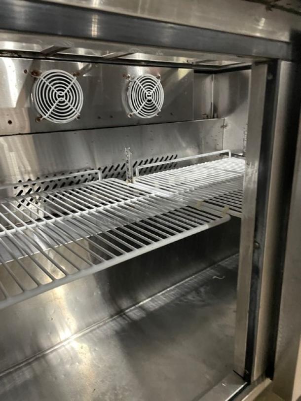 Atosa MSF8302 stainless steel refrigerated prep table, featuring two doors, poly-coated wired rack, on casters, excellent condition.