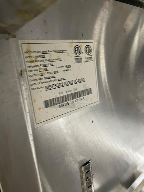 Atosa Model MSF8302 tag on refrigerated prep table, showing specs and serial number. Stainless steel surface marked "Made in China."