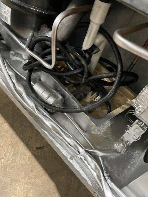 Close-up of Atosa MSF8306 refrigerated prep table components, showing internal wires and tubing. Condition: good.