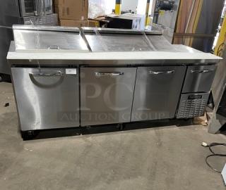 Continental RA93N30M Stainless Steel 3.5 Door Refrigerated Bain Marie Prep Table with cutting board, poly rack, on casters.