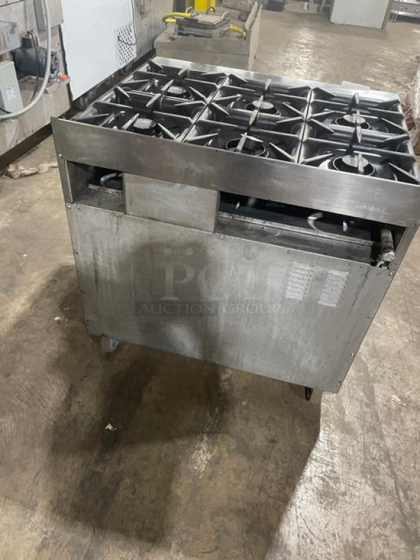 Electrolux commercial stainless steel 6-burner range and static oven. Features cast iron burners, wired oven rack, on casters.