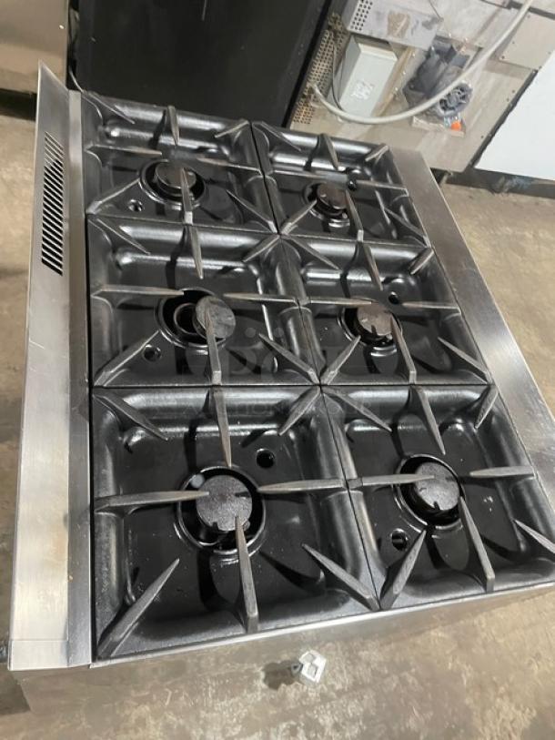 Electrolux commercial stainless steel 6-burner range with cast iron burners, natural gas, static oven, on casters, wired oven rack.