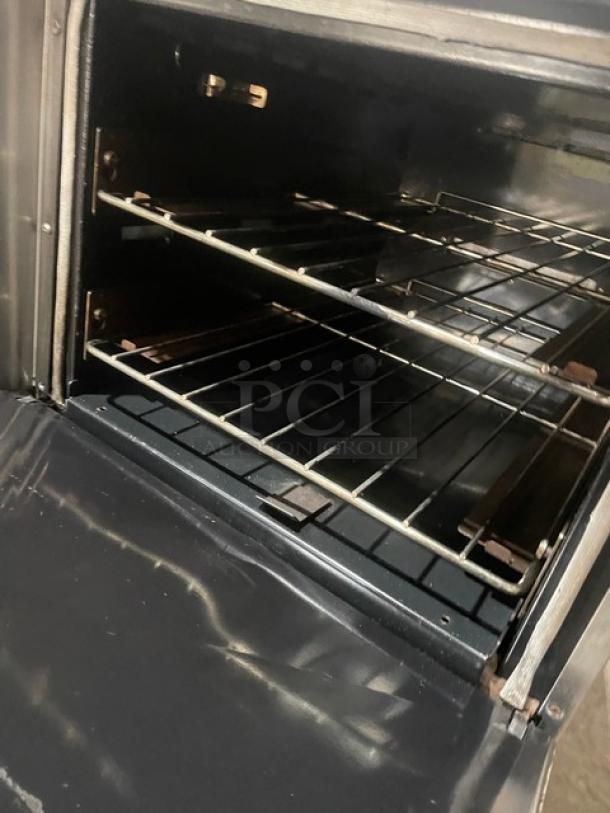 Electrolux commercial stainless steel 6-burner range and oven combo with wired oven rack, cast iron burners, on casters.