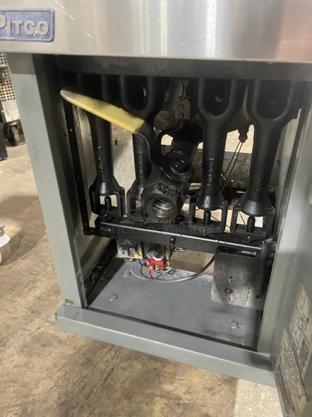 Pitco 45C commercial stainless steel natural gas deep fryer's interior, featuring burners and wiring, with visible labels.