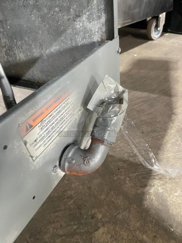 Pitco 45C commercial stainless steel gas fryer, 42 lb capacity, visible pipe with tape, caution label attached.