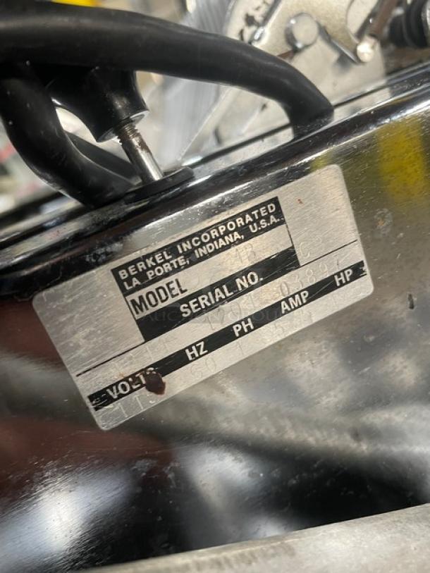Berkel stainless steel electric bread slicer, Model MB, SN: 9211120103897, 115V, 1 phase, on legs, shown with label.