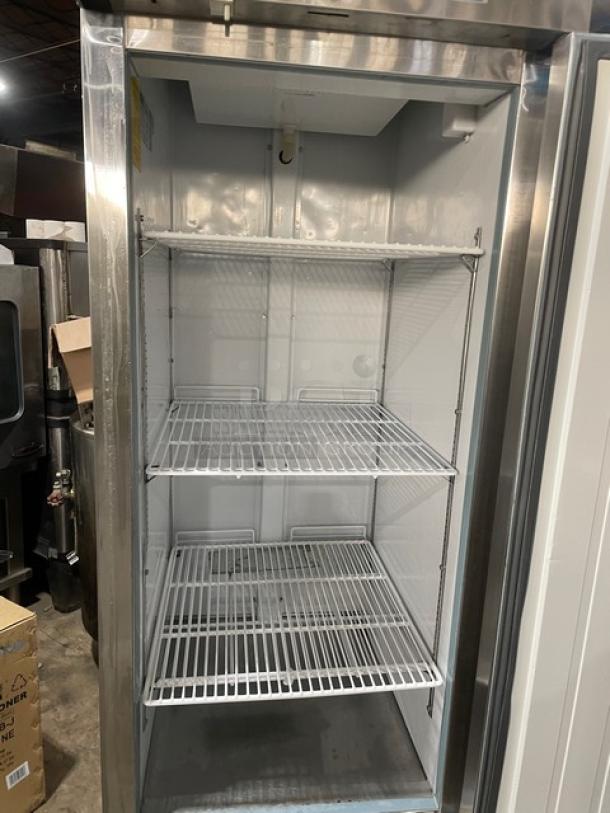 Arctic Air AR23E stainless steel single-door refrigerator, Energy Star certified, with poly-coated wire rack, on casters.
