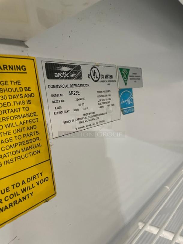 Arctic Air AR23E commercial refrigerator label, UL and Energy Star marks, cautions, model details, poly rack visible.