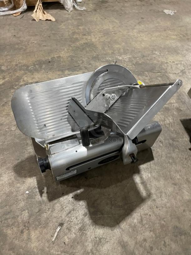Globe 500L heavy-duty deli slicer, electric-powered, countertop model, in good condition, with visible serial number 882440.
