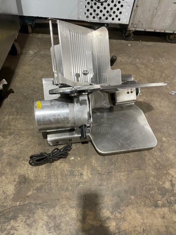 Globe Model 500L heavy-duty meat slicer, electric-powered, countertop design with legs. Visible cord and sturdy construction.