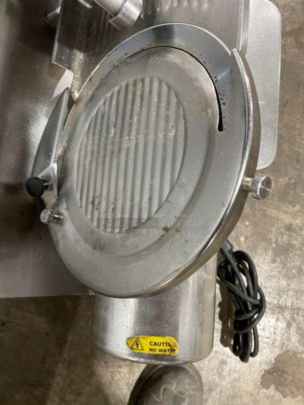 Globe Model 500L heavy-duty meat slicing machine, silver, with "Caution: No Water" label. Electric, countertop, on legs.