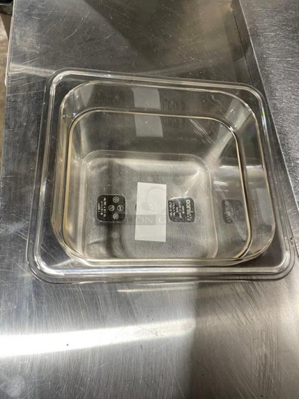 Winco SP7604 clear polycarbonate 1/6-size 4" deep food pan, brand new, on metal surface.