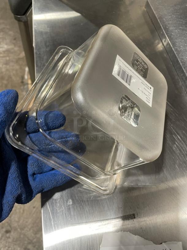 Brand new Winco SP7604 clear polycarbonate food pan, 1/6-size, 4" deep. Label showing model and barcode visible on the lid.