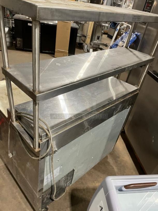Turbo Air TPR44SD stainless steel pizza prep table with cutting board, double overhead shelf, chrome rack, on casters.