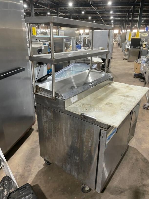 Turbo Air TPR44SD commercial pizza prep table with cutting board, double overhead shelf, and chrome plated rack. Stainless steel, on casters.