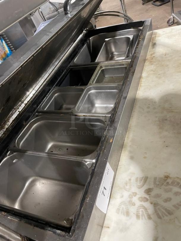 Turbo Air TPR44SD refrigerated pizza prep table, stainless steel, with cutting board, overhead shelf, steamtable pans, on casters.