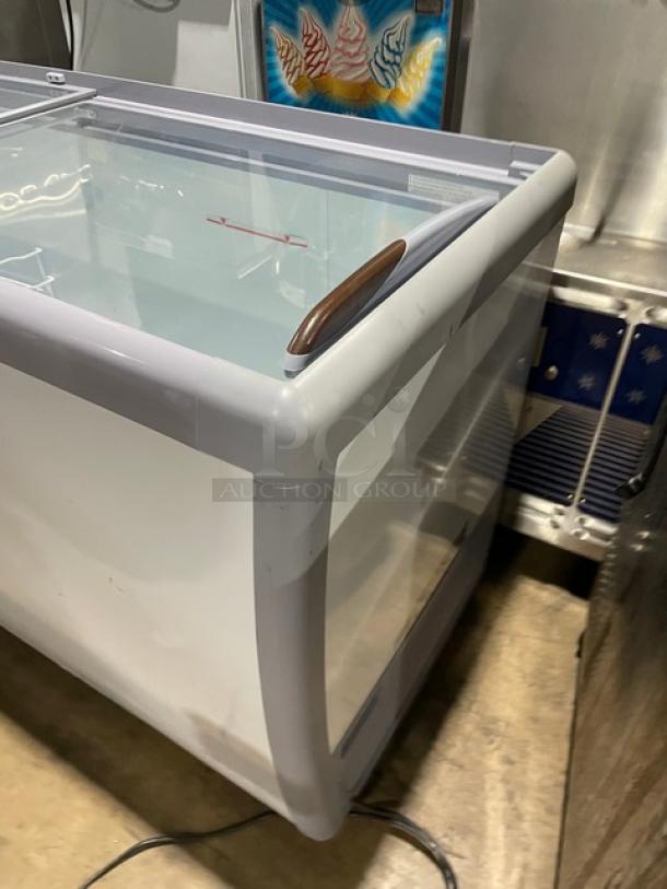 Avantco 70" flat-top ice cream display freezer, model 360DFF20HCL, with double glass sliding doors, on casters.