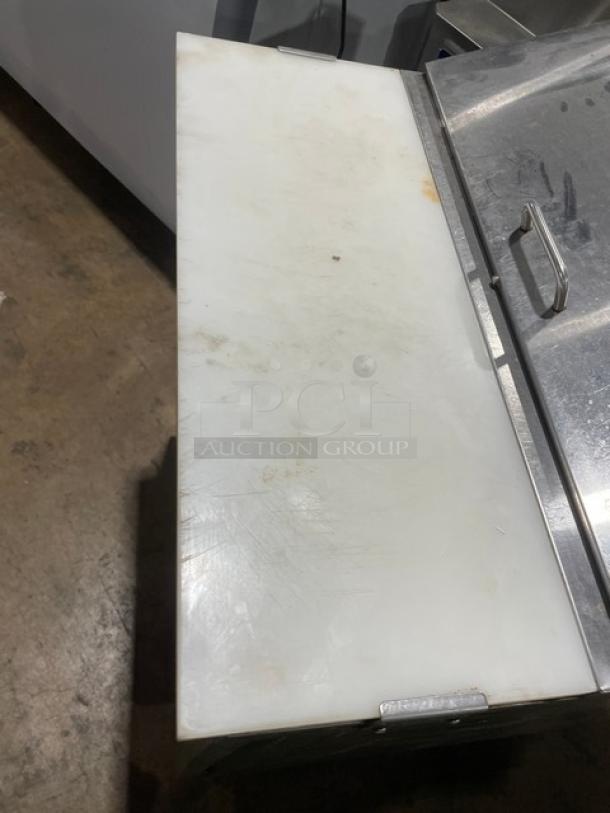 Avantco SCL Series refrigerated prep table, model 178SCL1, with stainless steel finish, cutting board, and casters.