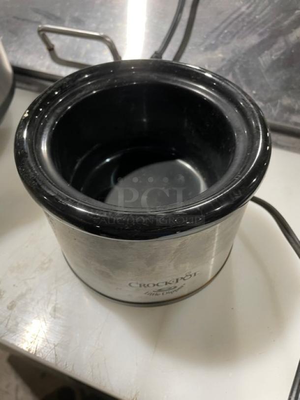 Crock-Pot SCR503 5 Qt. stainless steel slow cooker with handles and black lid. Features power cord. Good condition.