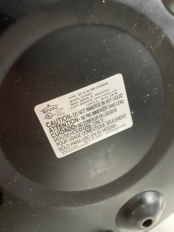Crock-Pot SCR503 5 Qt. stainless steel slow cooker, electric powered, with handles and lid. Model label visible, 120V.