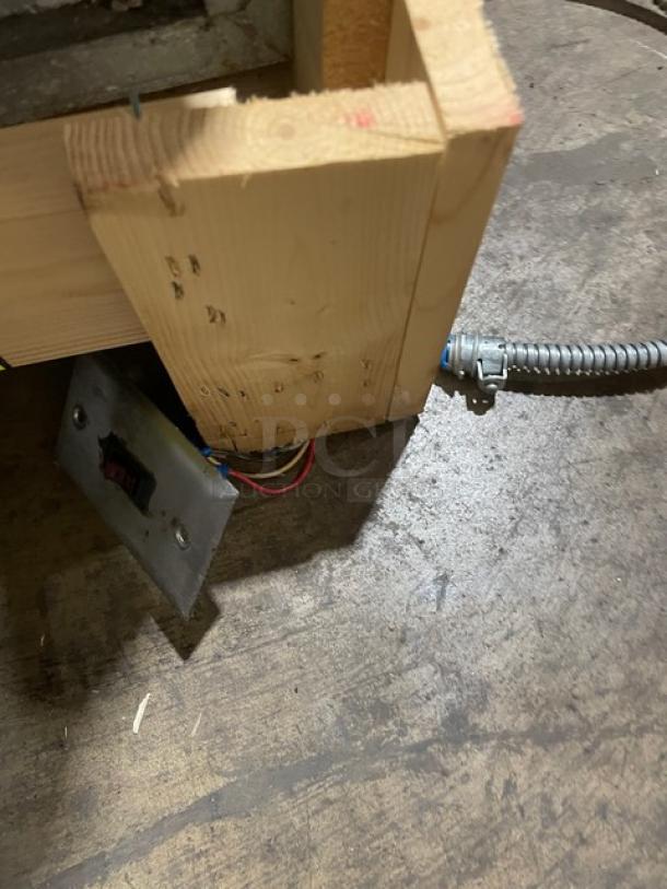 Atlas Metal stainless steel electric refrigerated drop-in cold unit, wired and mounted in a wooden frame, seen from below.
