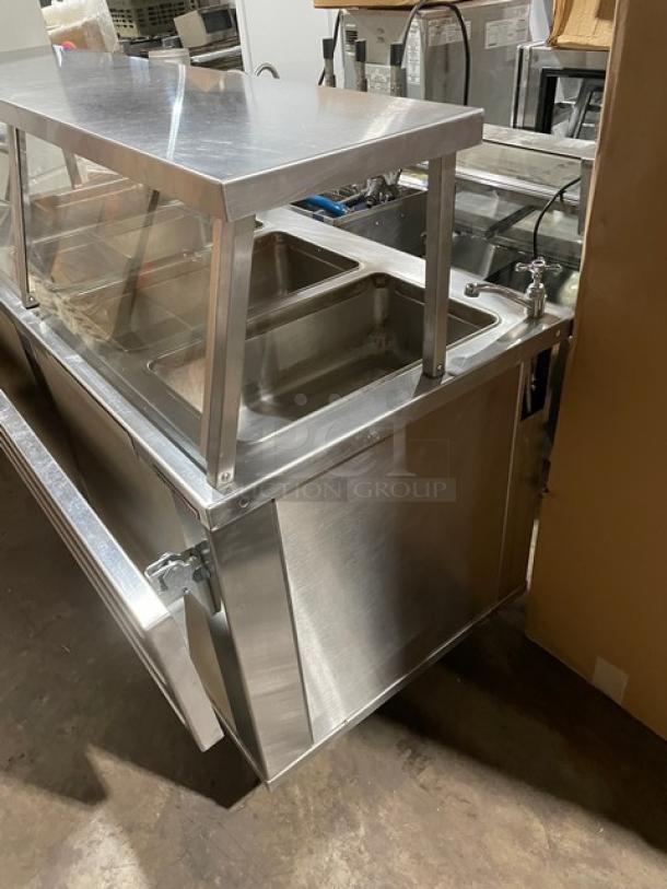 Piper Products 4HF stainless steel heated buffet counter with sneeze guard, foldable tray slides, and enclosed dry shelf base.