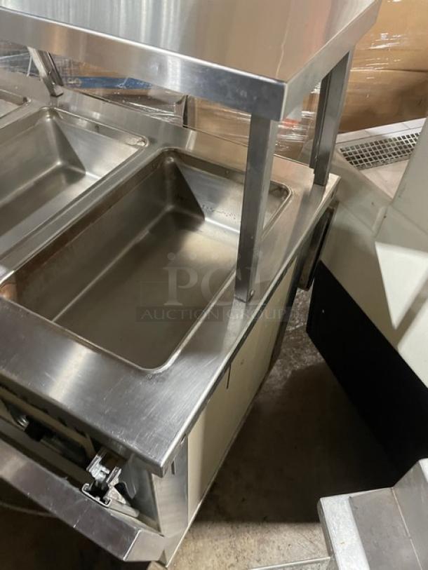 Piper Products 4HF stainless steel heated buffet counter, 4 wells, sneeze guard, foldable tray slides, enclosed shelf, 208V, 1 phase.