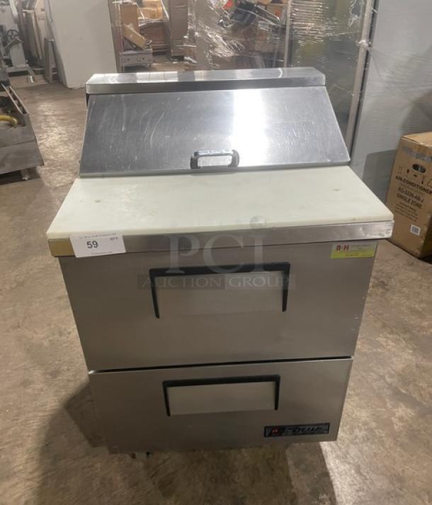 True Commercial Stainless Steel 2-Drawer Refrigerated Prep Table, Model TSSU-27-08D-2, with cutting board on casters.