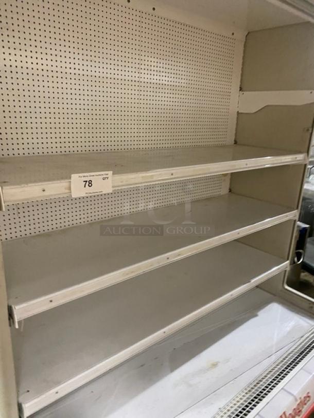 Hussmann MD14 refrigerated open merchandiser with pull-down night curtain, multi-tier shelves, white, model MD14, SN: MY09N055552.
