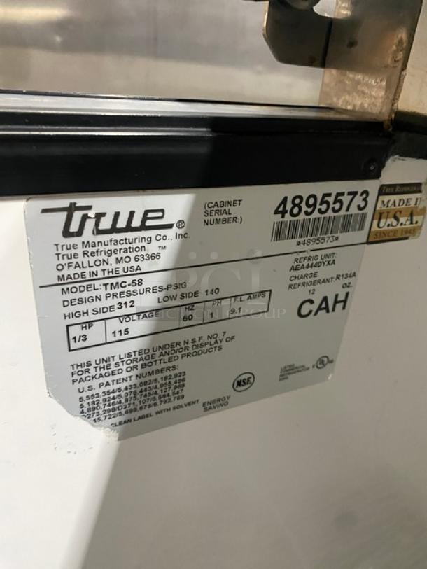 True Commercial TMC-58 milk cooler in white and stainless steel, featuring a poly-coated wired rack. Model TMC-58, SN 4895573, 115V, 1 phase.
