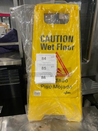 Brand new 24" yellow Update International WFS25 caution/wet floor sign in packaging, indicating slip hazard.