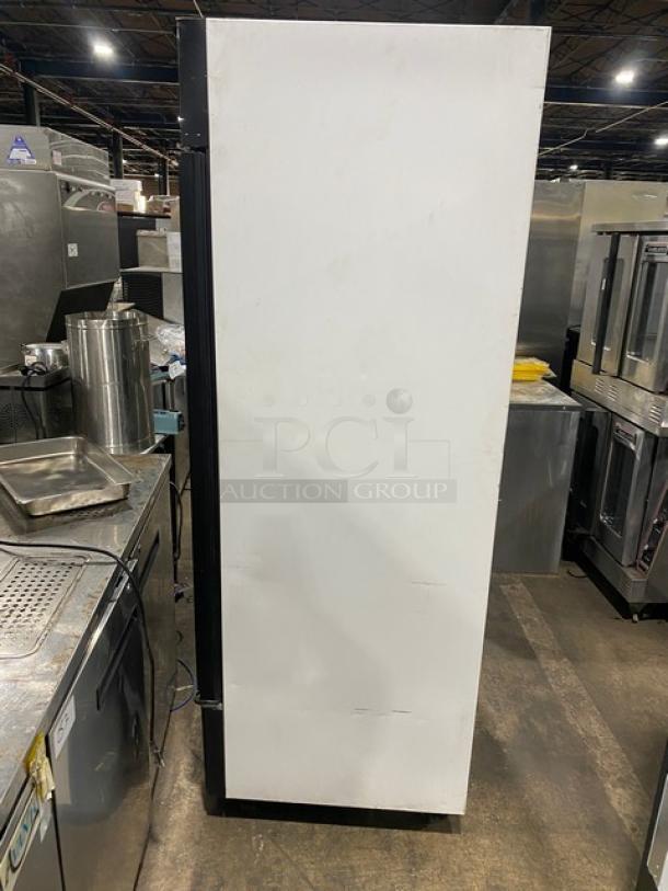 True GDM49FLD commercial freezer with double glass doors, poly coated racks, Energy Star certified, on casters, side view.