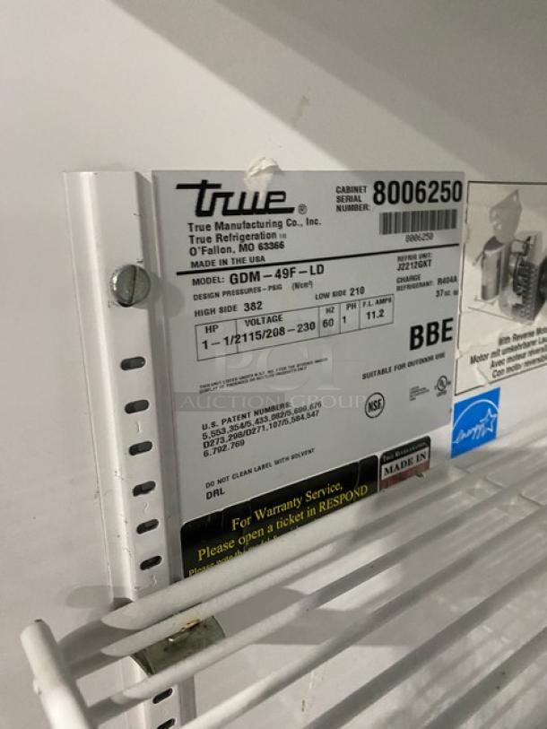 True Commercial Black Double Glass Swing Door Merchandiser Freezer, Model GDM-49F-LD, Energy Star Certified, with poly coated wired rack, serial number 8006250, 115/208-230V, 1 phase, on casters.
