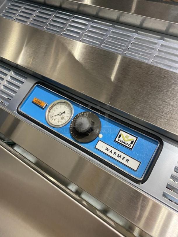 Victory stainless steel 2-door roll-thru heated holding cabinet with dual compartment controls. Visible temperature gauge and control dial.
