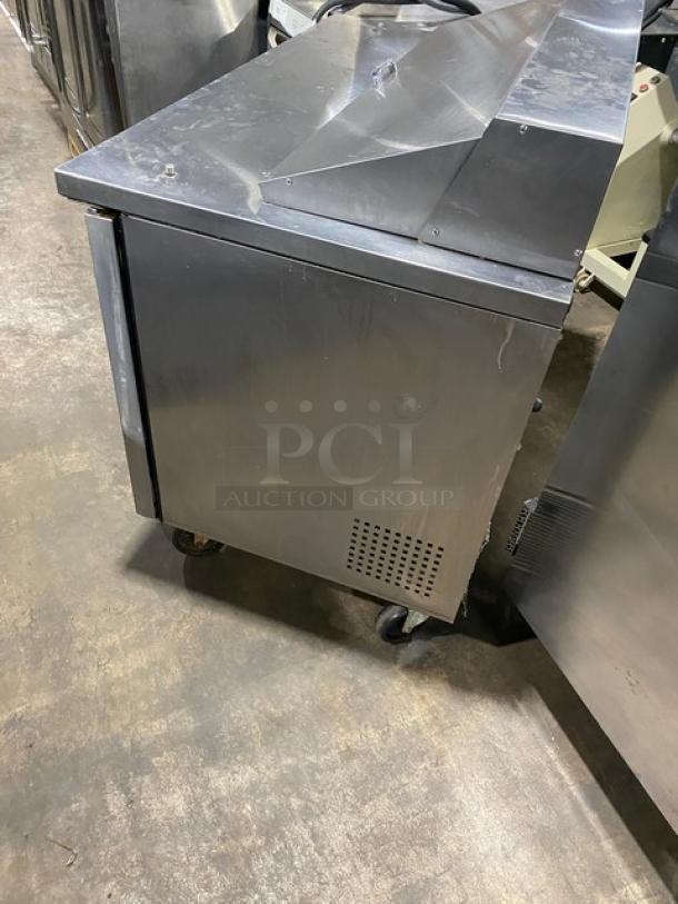 True TSSU-48-12 refrigerated prep table, stainless steel, two doors, on casters, commercial quality, good condition.