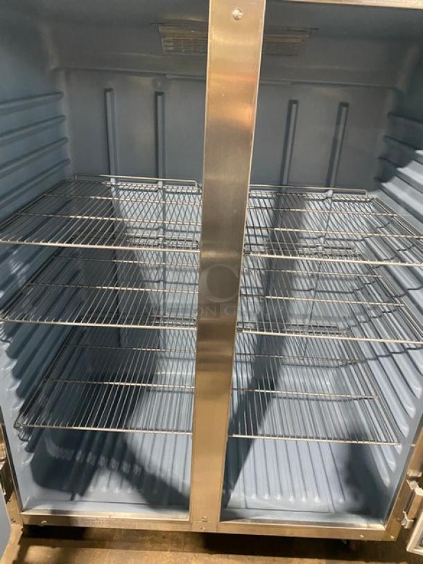 Delfield 6151XL-S stainless steel 2-door reach-in freezer, Energy Star certified, with poly coated wired rack, on casters.
