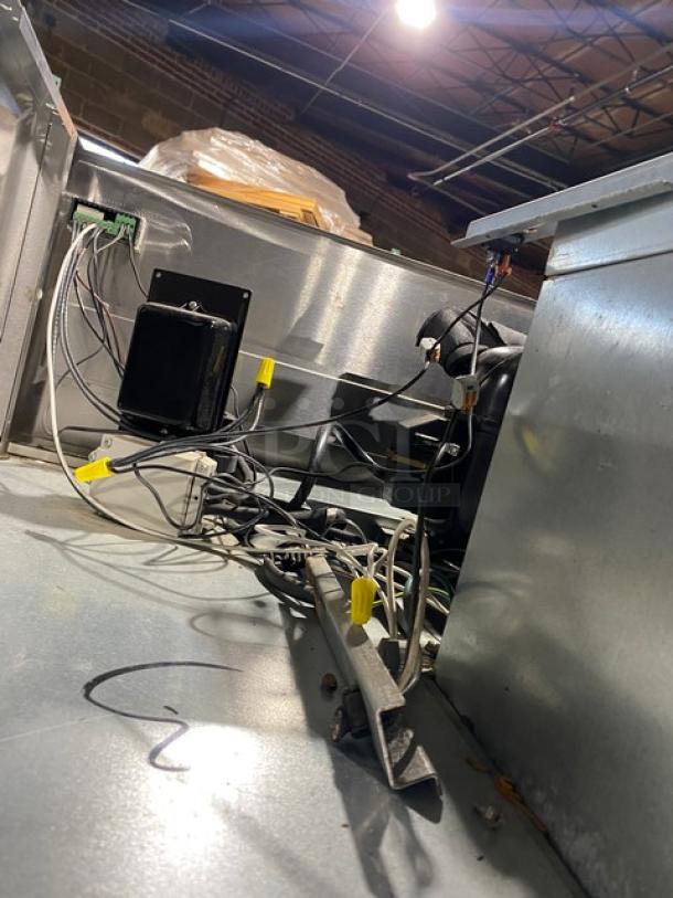Interior view of a Delfield 6151XL-S commercial freezer showing wiring and components, emphasizing its solid construction.