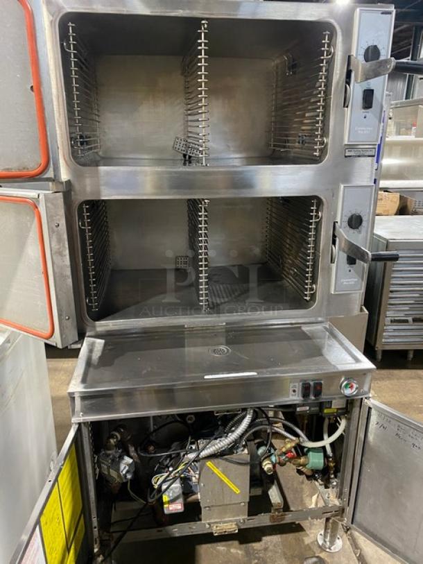 Cleveland Range Pro-XVI Series dual compartment convection steamer, stainless steel, Model 36CGM16300, natural gas, 16-pan capacity, open doors showcasing interior racks and controls, on legs.