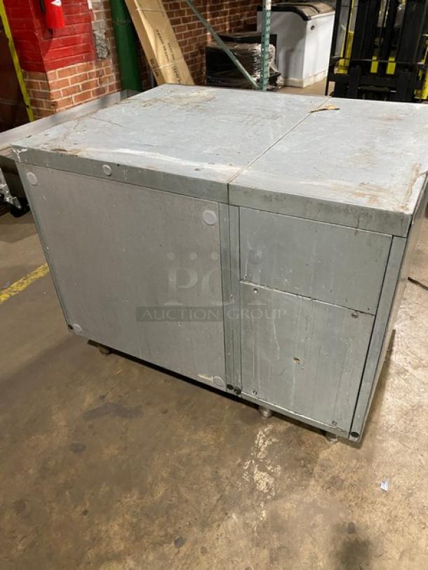 Traulsen stainless steel single door undercounter freezer, model UC1LT, with chrome-plated wire rack, on legs.