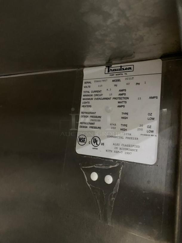 Traulsen Commercial Stainless Steel Undercounter Freezer, Model UC1LT, with label showing specs and certifications.