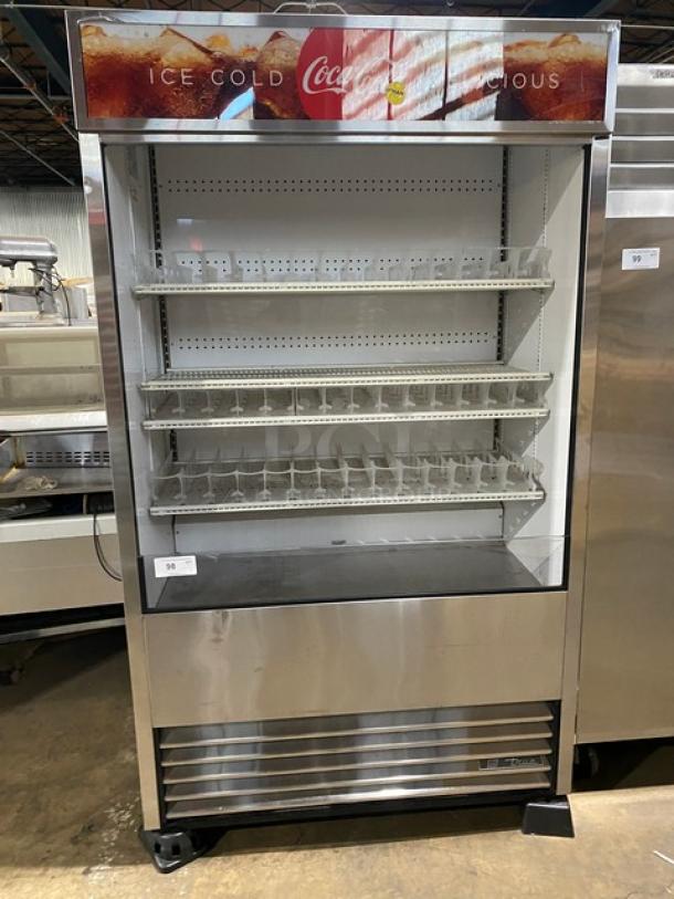 True Coca-Cola style stainless steel merchandiser, model TAC48LD, with adjustable wire rack and plastic organizer.