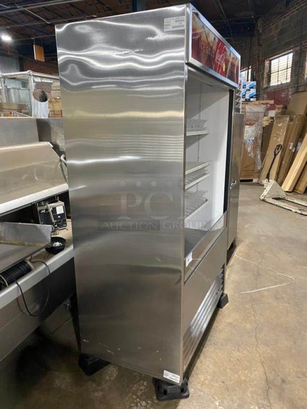 True TAC48LD stainless steel open grab-n-go merchandiser with adjustable wire rack, plastic beverage organizer, on legs.