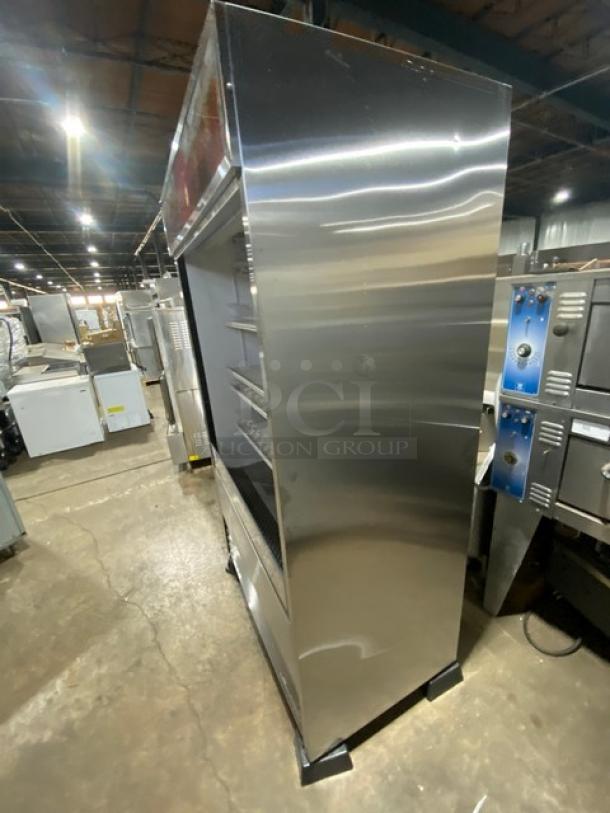 True TAC-48-LD stainless steel refrigerated merchandiser with adjustable wire rack, plastic organizer, and legs, in good condition.