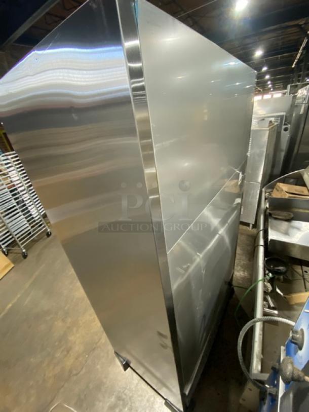 True Coca-Cola style stainless steel refrigerated merchandiser, model TAC48LD, with adjustable wire rack and beverage organizer, on legs.