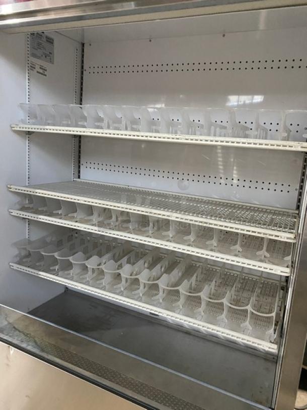 True Coca-Cola style stainless steel refrigerated display case, model TAC-48-LD, with multi-tier wire racks and beverage organizer.