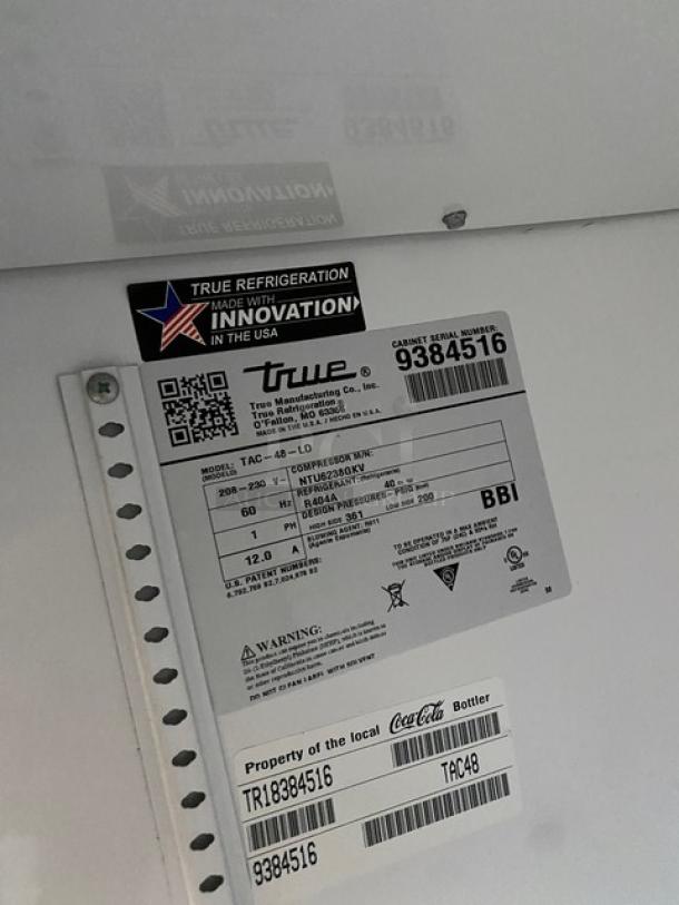 True Coca-Cola style commercial refrigerator label, Model: TAC-48-LD, Serial: 9384516, 208-230V, 1 Phase, USA made.