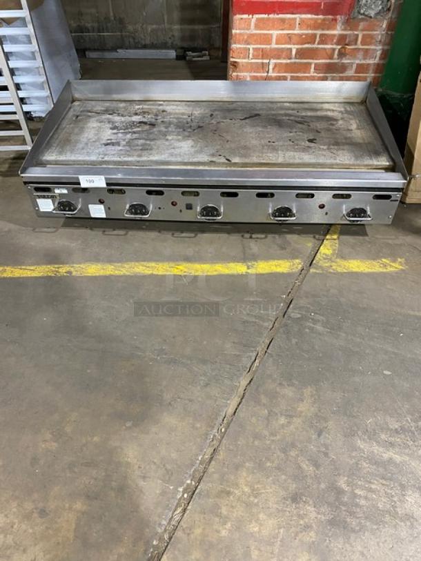 Vulcan stainless steel natural gas countertop flat griddle with thermostatic control, back and side splash, on legs.
