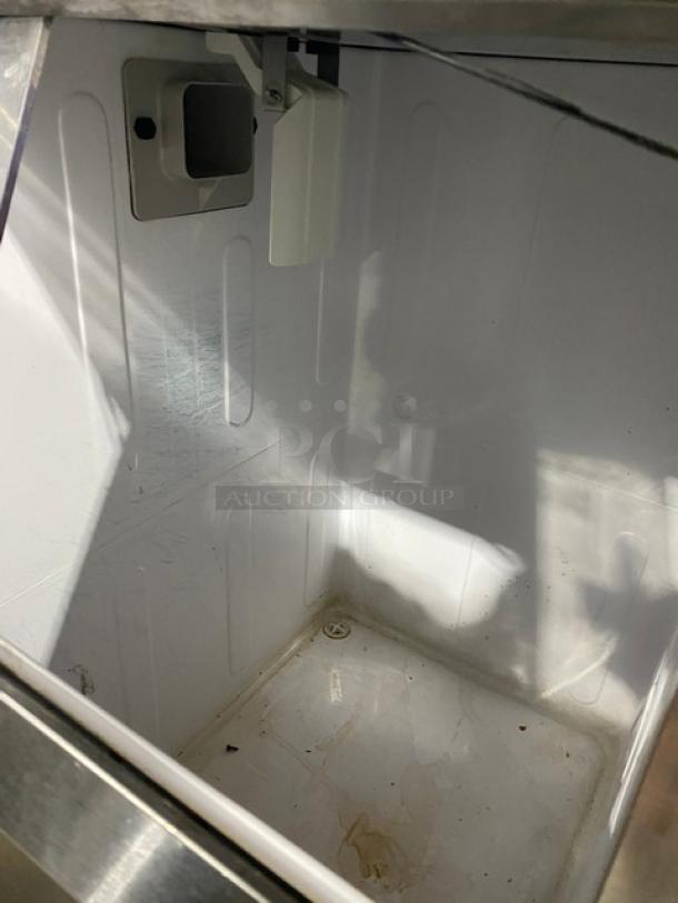 Hoshizaki F-500BAJ ice maker interior, clean white finish, stainless steel exterior, model and serial number visible.
